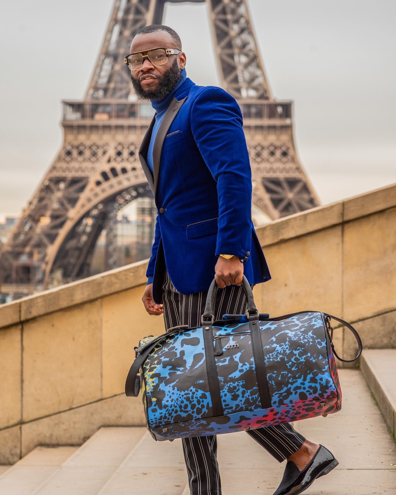 Man in a blue velvet blazer near the Eiffel Tower