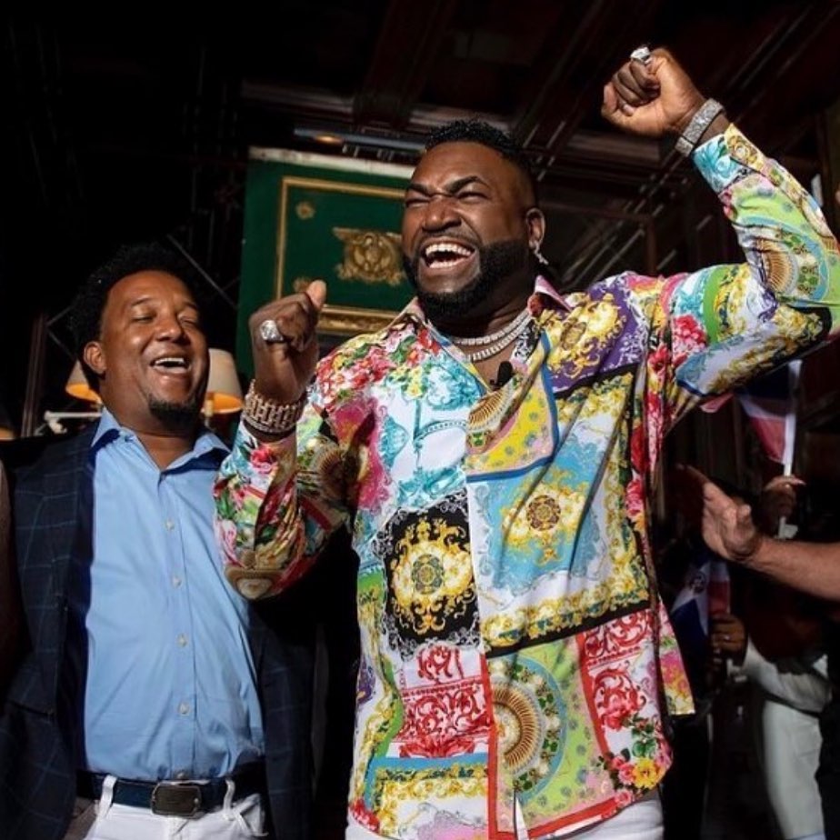 Man celebrating in a multicolored patterned shirt
